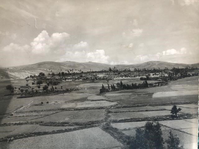 Mangeshi Village in the 1960's nestled between a hill and mountain. Photo by Francis K. Khosho collection