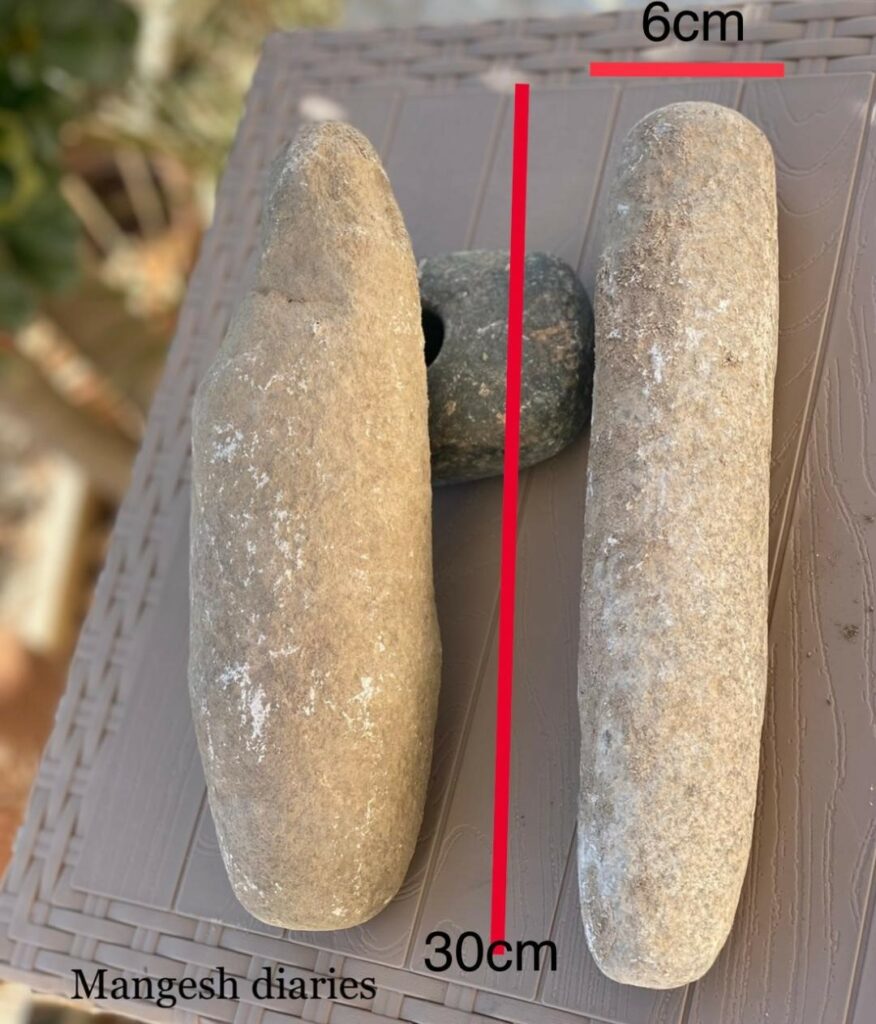 Mangeshi realty grinding stone pestle approximately 6x30 cm, flattened oval shape.