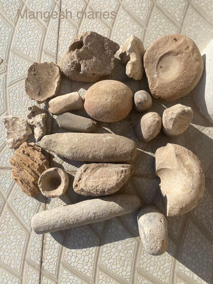 Mangeshi realty millstones and grinding stone pestles. Note the bowl hand carved from rock, probably a medicine bowl (arrow).